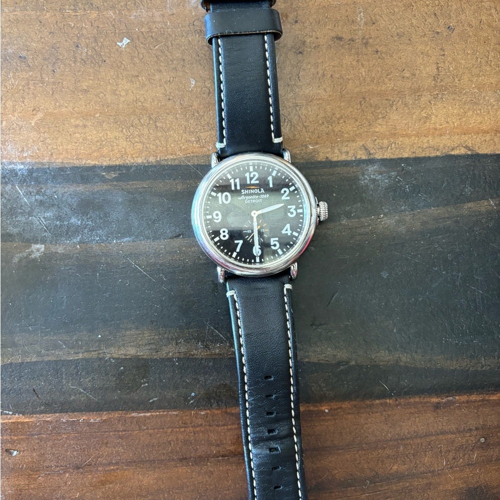 Men’s black leather Shinola watch with black face.